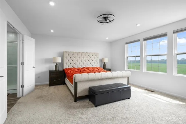 a bedroom with a bed and a large window