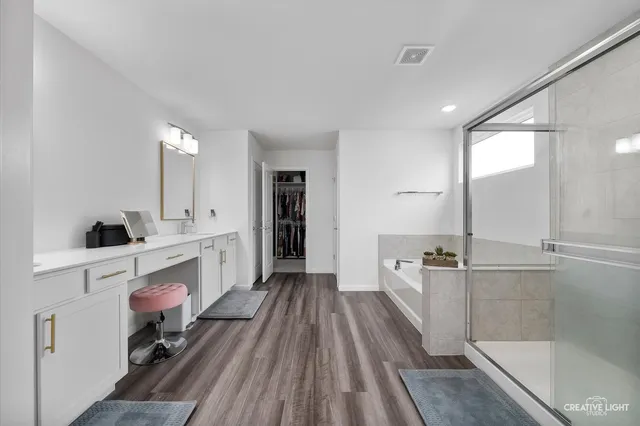 a view of a kitchen with a sink and wooden floor