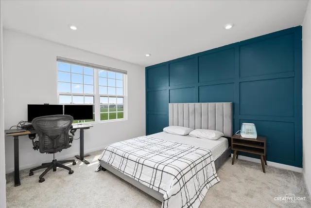 a bedroom with a bed and a workspace