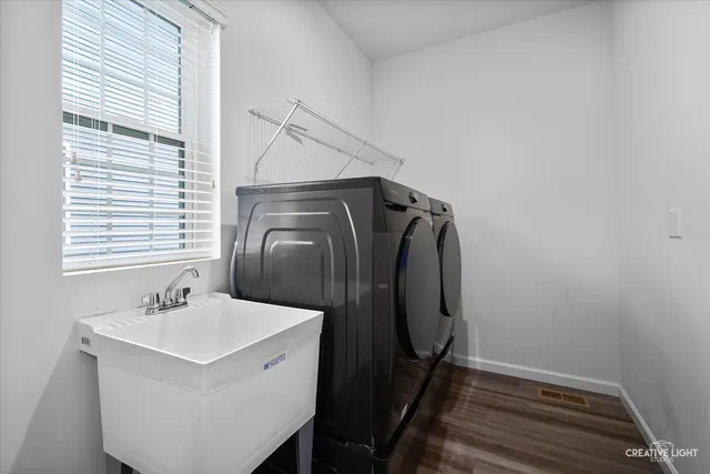 a bathroom with a sink and mirror with window