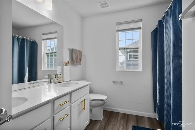 a bathroom with a granite countertop sink toilet a large mirror and shower