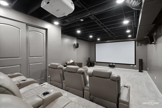 a media room with lots of chairs and a projector screen