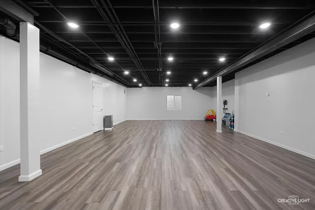 a view of an empty room with wooden floor