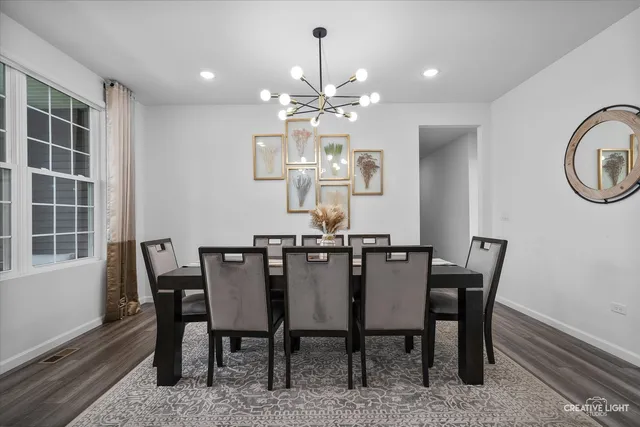 a view of a dining room with furniture and chandelier