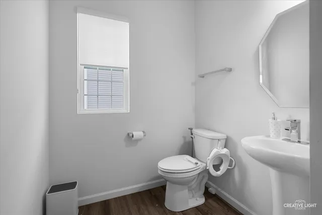 a white toilet sitting next to a bathroom sink