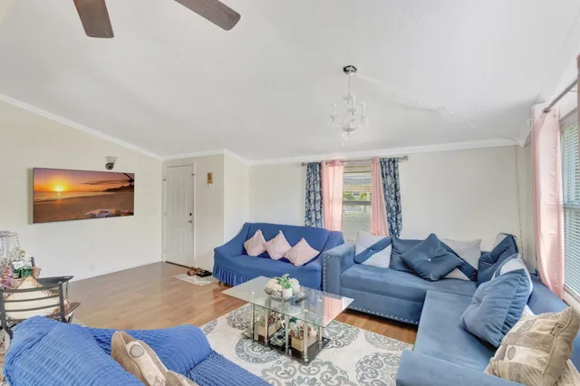 a living room with furniture chess board and a flat screen tv