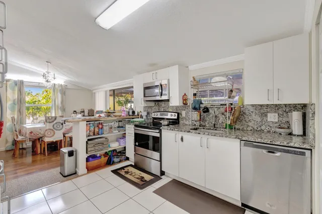 a kitchen with lots of appliances and cabinets