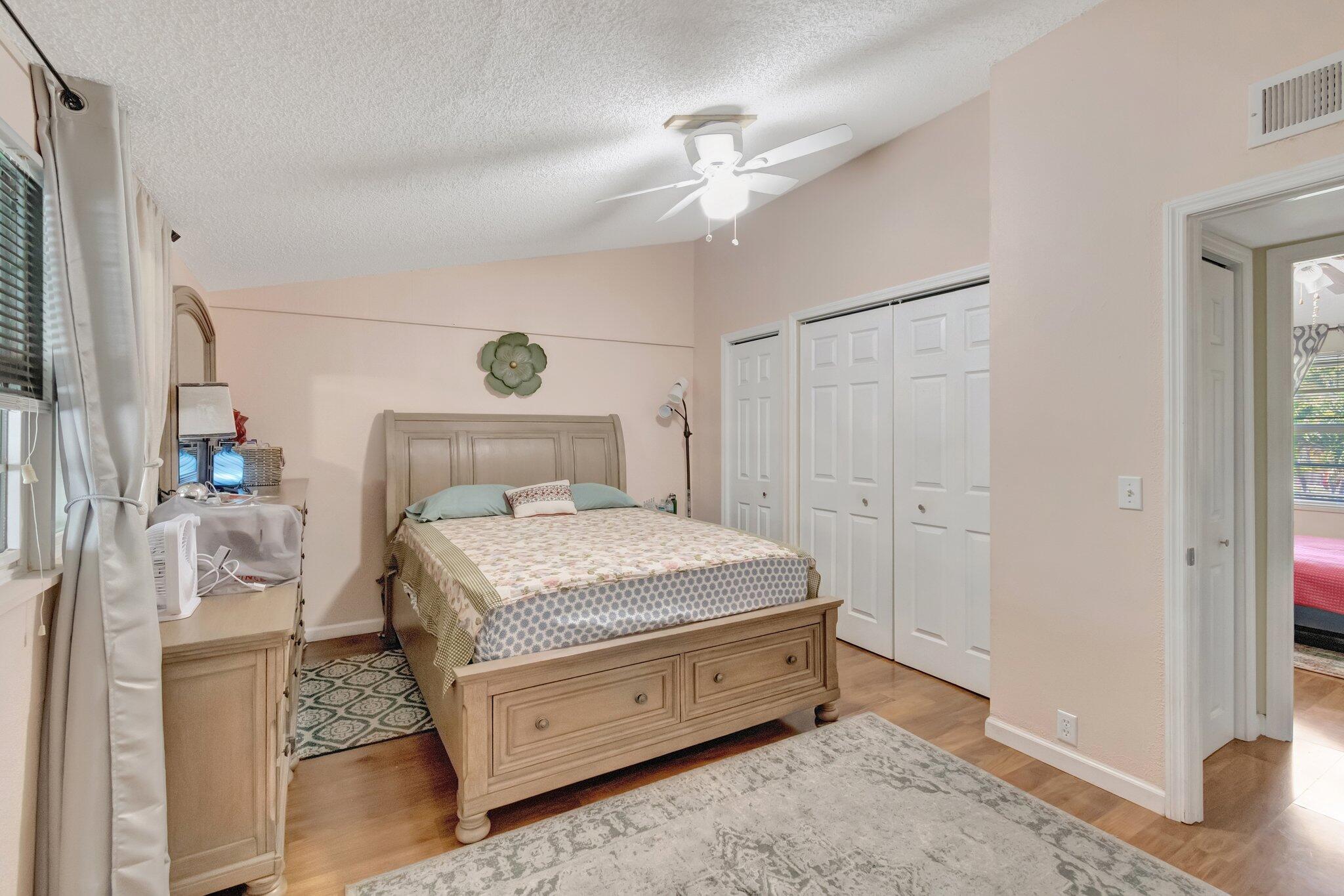 3935 Chickasha Road Atlantis, FL 33462 - Photo 20 of 44 a bedroom with a bed and a table