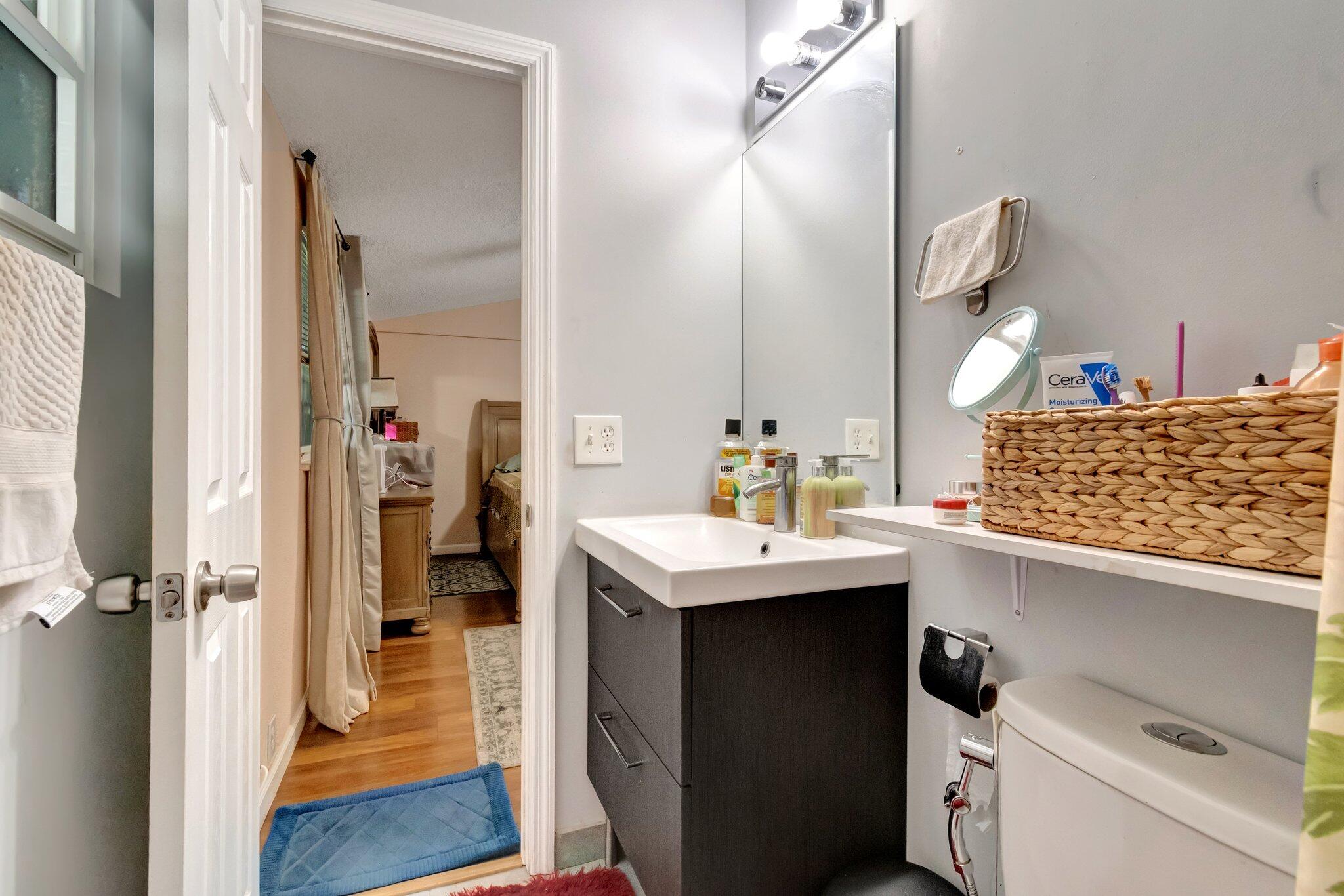 3935 Chickasha Road Atlantis, FL 33462 - Photo 24 of 44 a view of bathroom with a sink and mirror