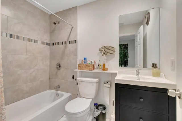 a bathroom with a sink toilet vanity and shower