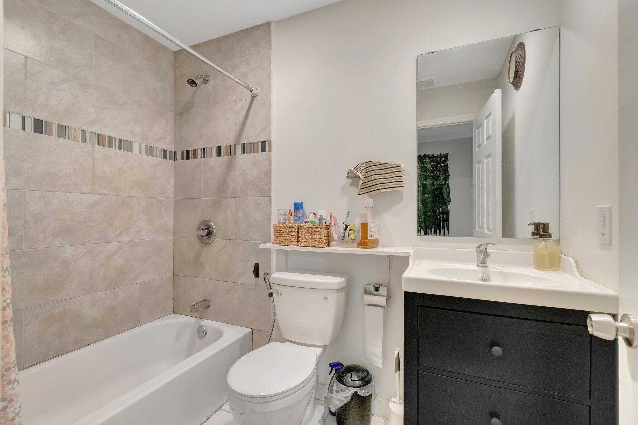 3935 Chickasha Road Atlantis, FL 33462 - Photo 28 of 44 a bathroom with a sink toilet vanity and shower