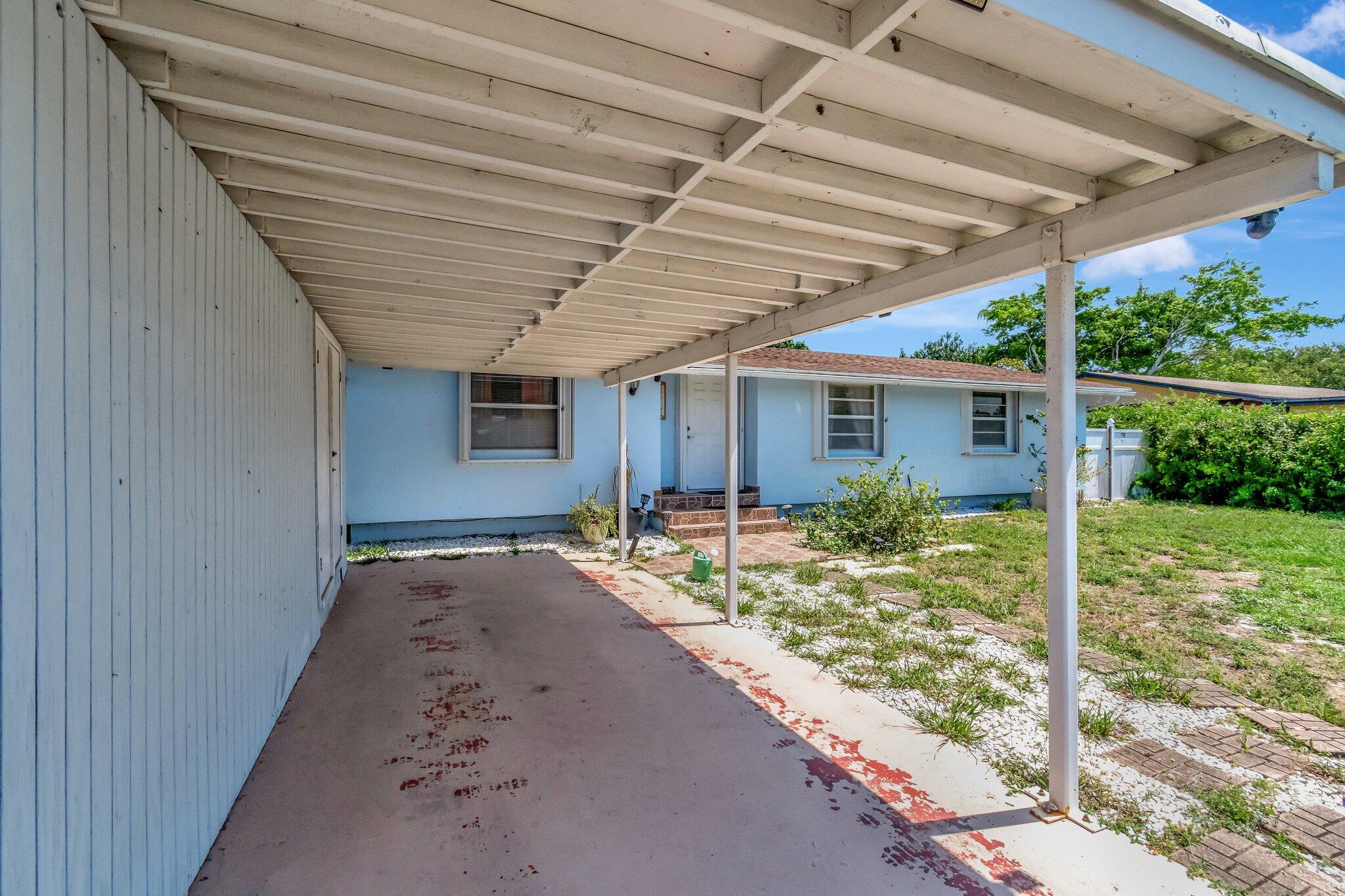 3935 Chickasha Road Atlantis, FL 33462 - Photo 30 of 44 a view of backyard with large tree