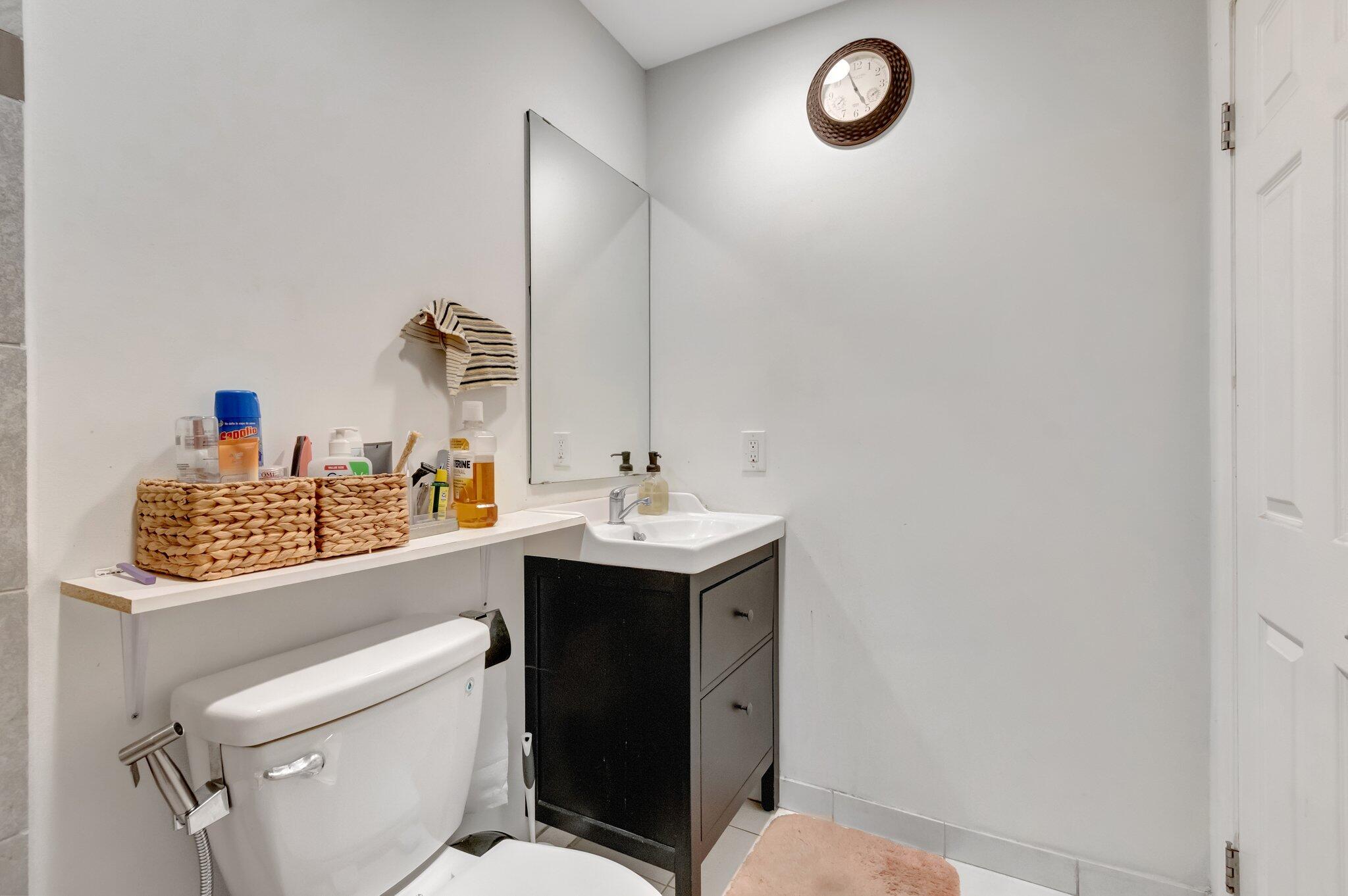 3935 Chickasha Road Atlantis, FL 33462 - Photo 31 of 44 a bathroom with a sink toilet vanity and vanity