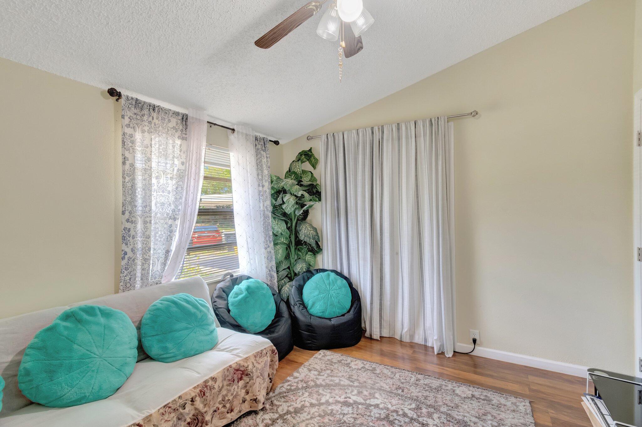 3935 Chickasha Road Atlantis, FL 33462 - Photo 33 of 44 a living room with furniture and a chandelier