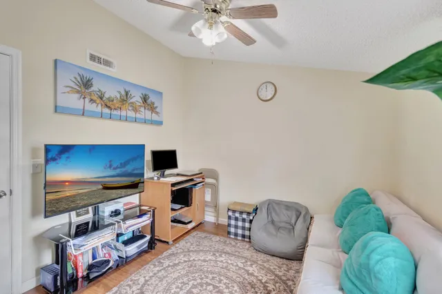 a bedroom with furniture and a flat screen tv