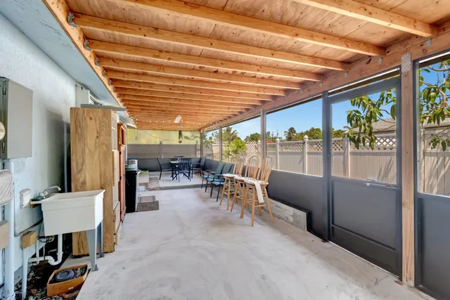 a view of a patio with table and chairs potted plants with wooden floor