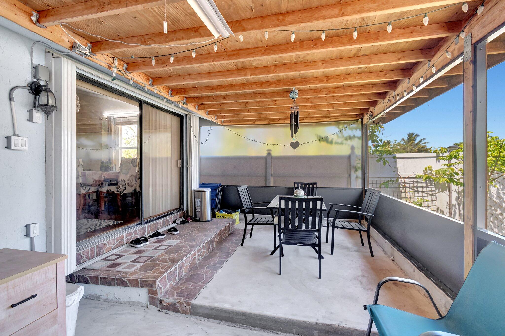 3935 Chickasha Road Atlantis, FL 33462 - Photo 38 of 44 a view of a dining room with furniture window and outside view