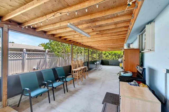 a view of a chairs and table in patio