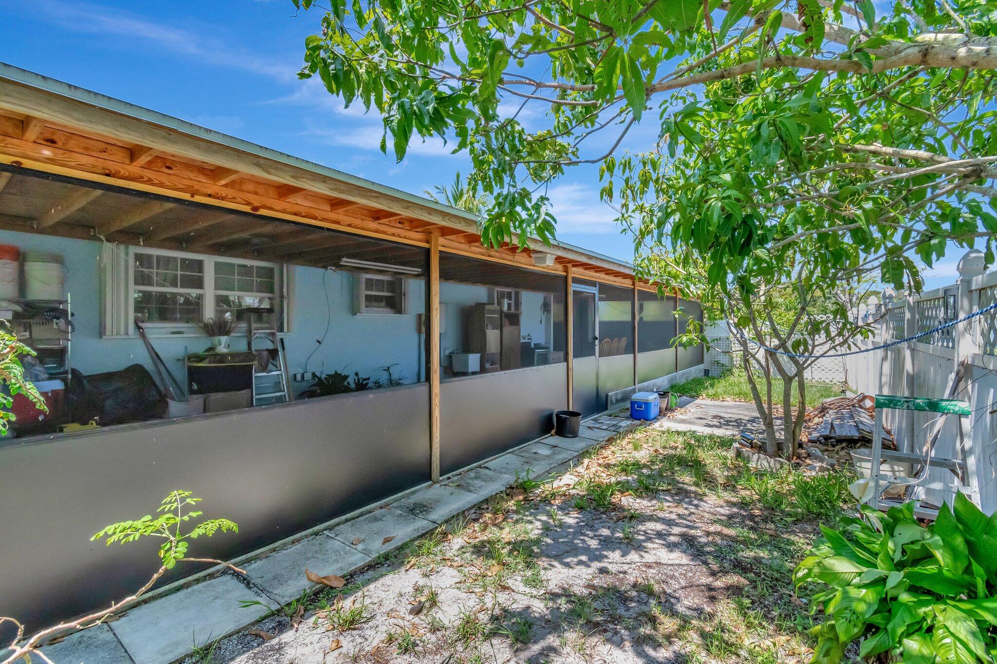 3935 Chickasha Road Atlantis, FL 33462 - Photo 42 of 44 a view of house with backyard and sitting area