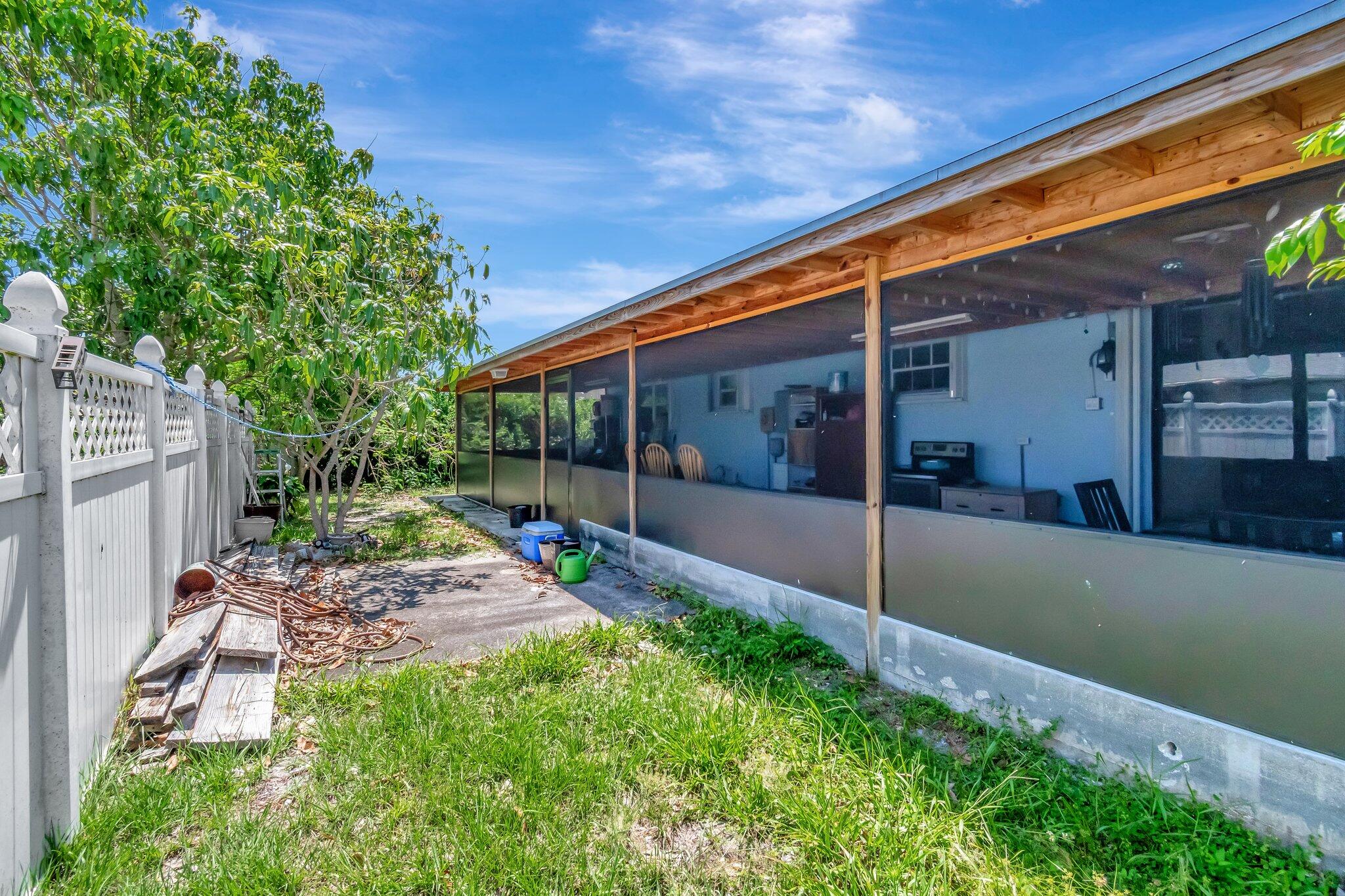 3935 Chickasha Road Atlantis, FL 33462 - Photo 43 of 44 a view of backyard with patio
