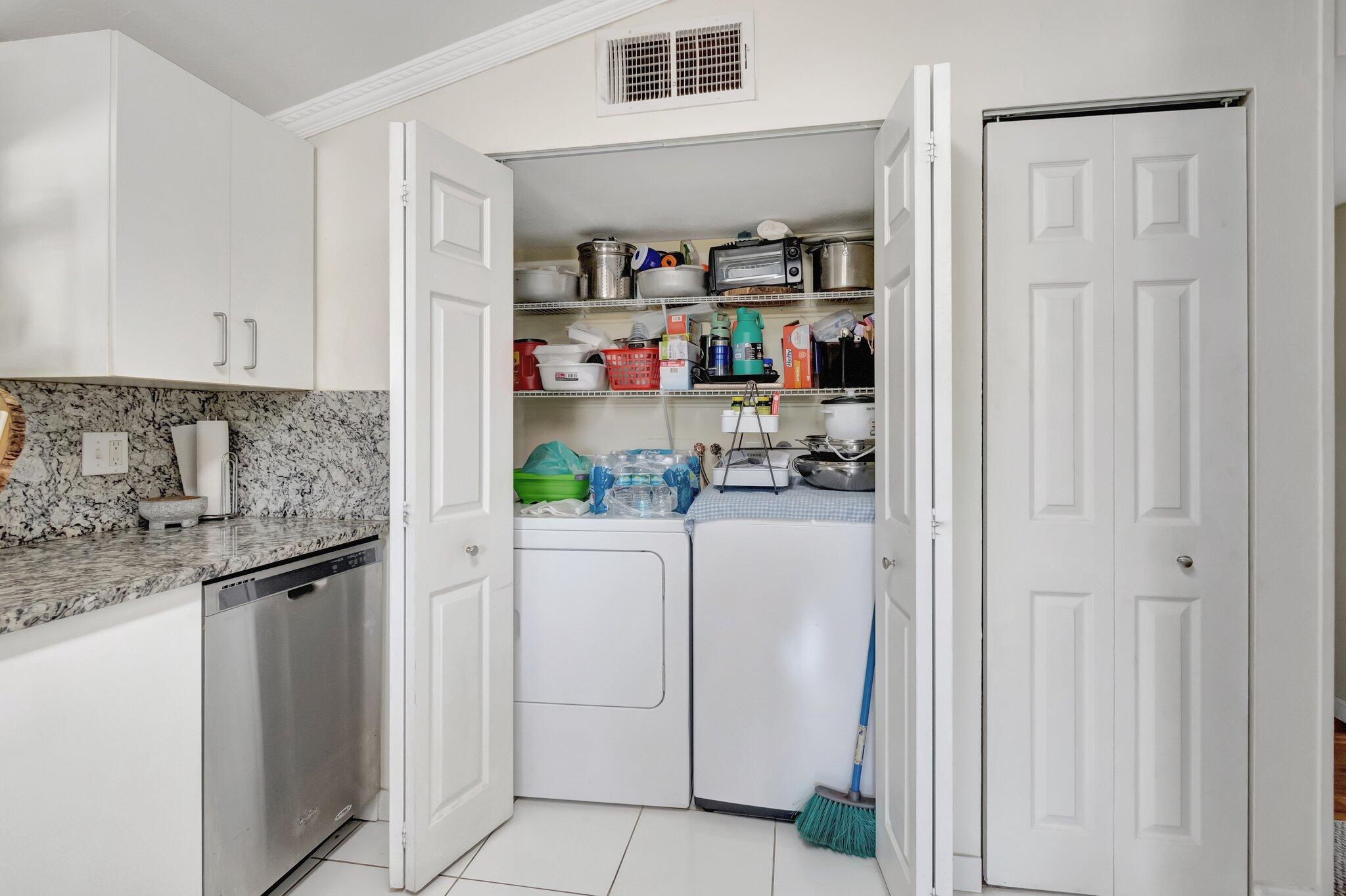 3935 Chickasha Road Atlantis, FL 33462 - Photo 44 of 44 a kitchen with stainless steel appliances granite countertop a refrigerator and a sink