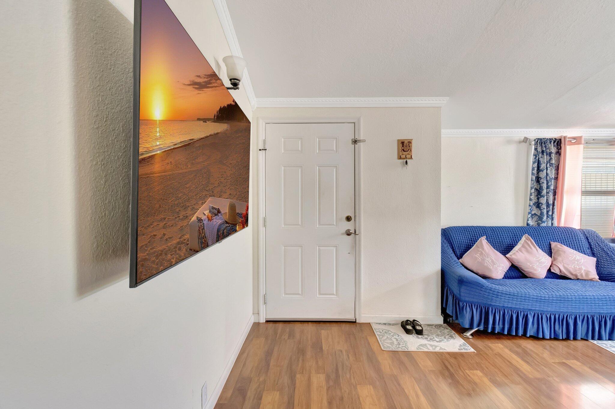 3935 Chickasha Road Atlantis, FL 33462 - Photo 8 of 44 a bedroom with a bed and wooden floor