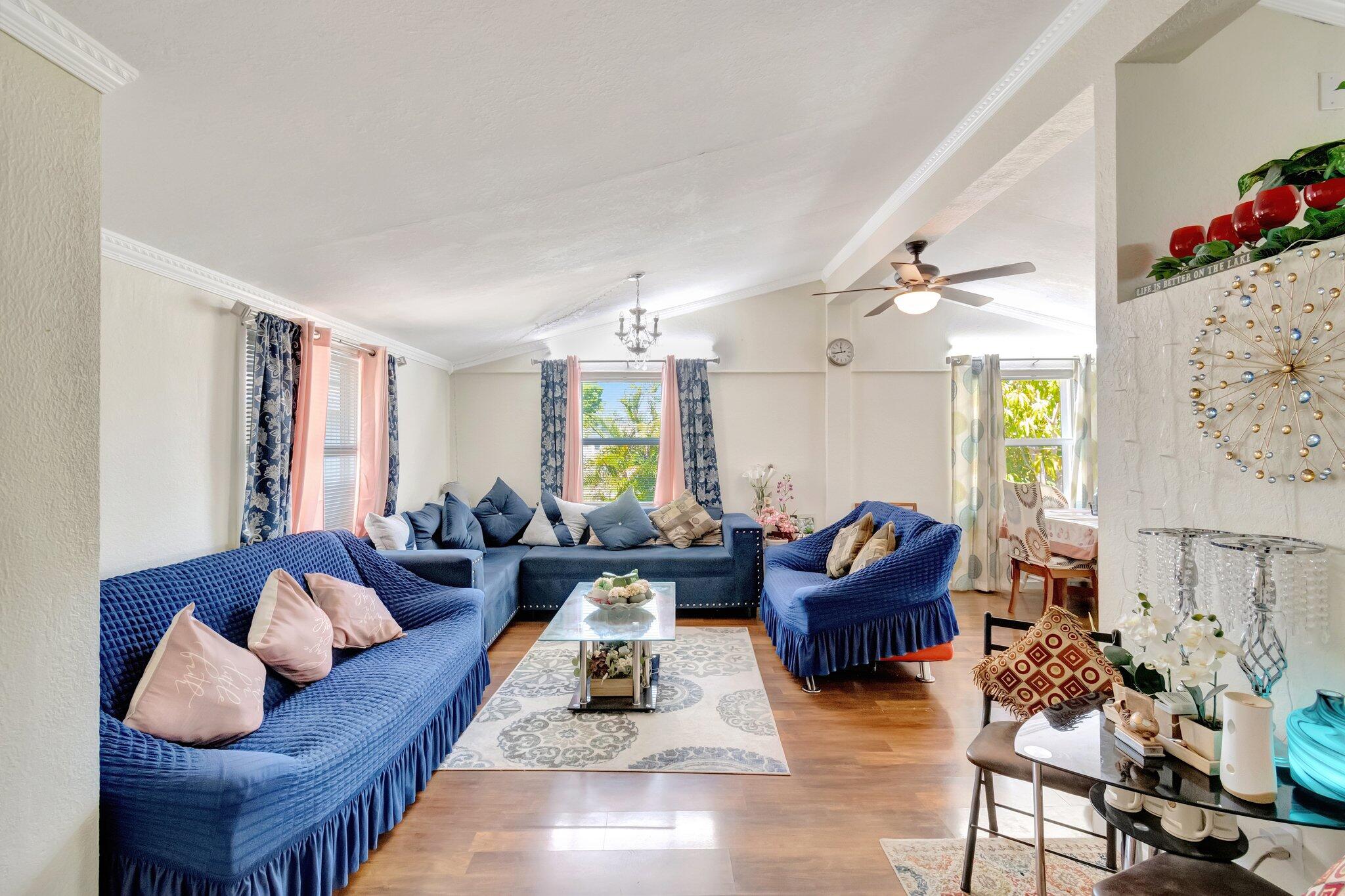 3935 Chickasha Road Atlantis, FL 33462 - Photo 10 of 44 a living room with furniture and a chandelier