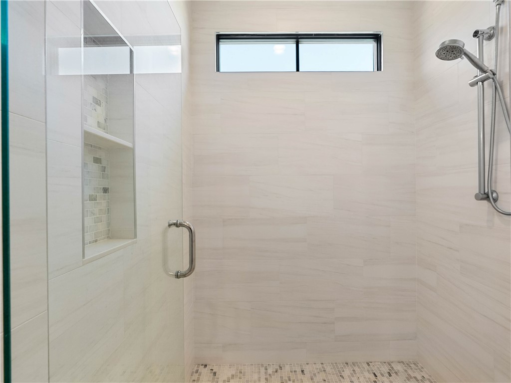 331 Bakerville Road Easley, SC 29642 - Photo 22 of 43 This sleek bathroom features a spacious shower with contemporary tile work and integrated shelving.