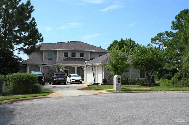 a front view of multiple houses with yard and green space