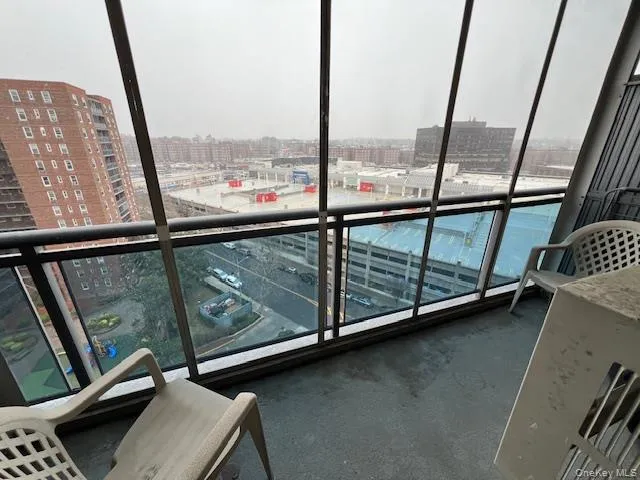 a view of an empty room with large windows