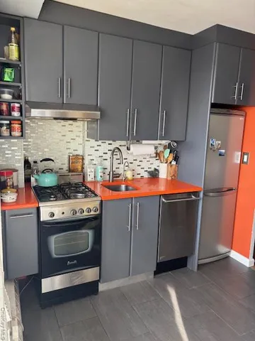 a kitchen with granite countertop a stove and a cabinets