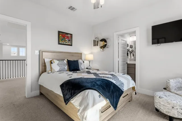 a bedroom with a bed and a flat screen tv