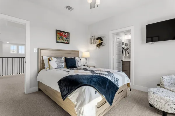 a bedroom with a bed and ceiling fan