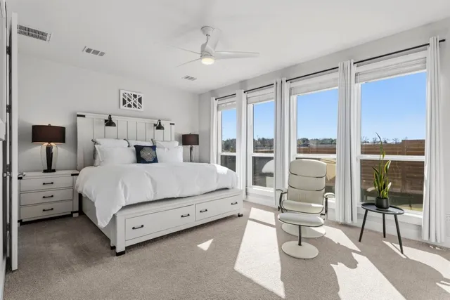 a bedroom with a large bed and a large window