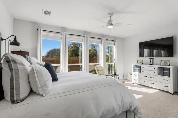 a bedroom with a large bed and a large window
