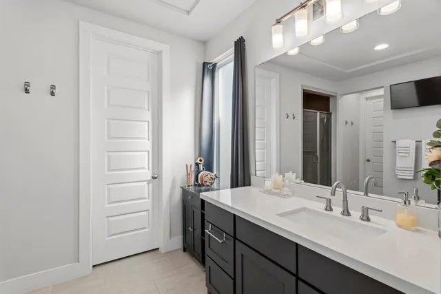 a bathroom with a double vanity sink and a mirror