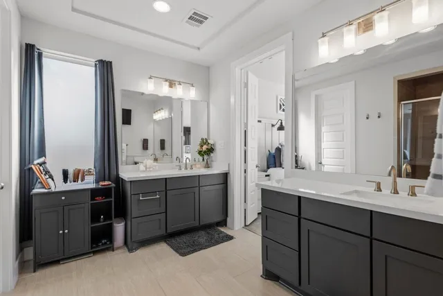 a bathroom with a double vanity sink mirror and double