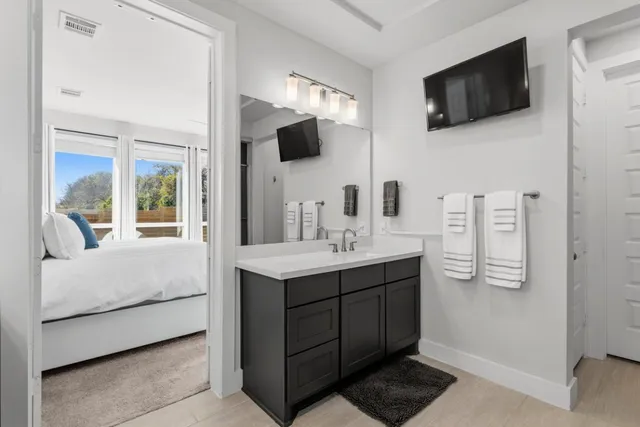 a en suite bathroom with a sink and a mirror