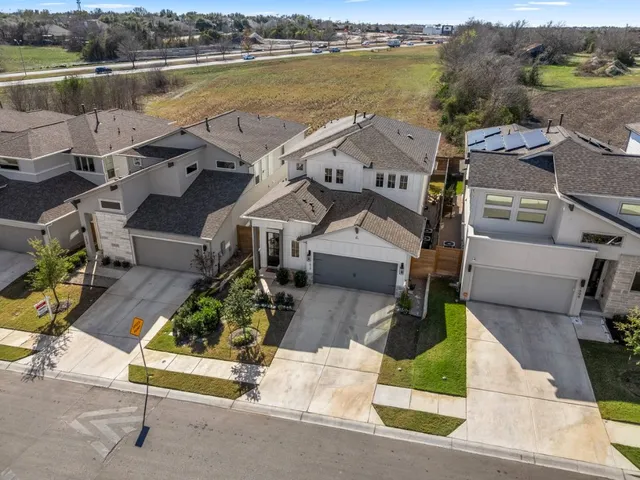 an aerial view of residential houses with outdoor space