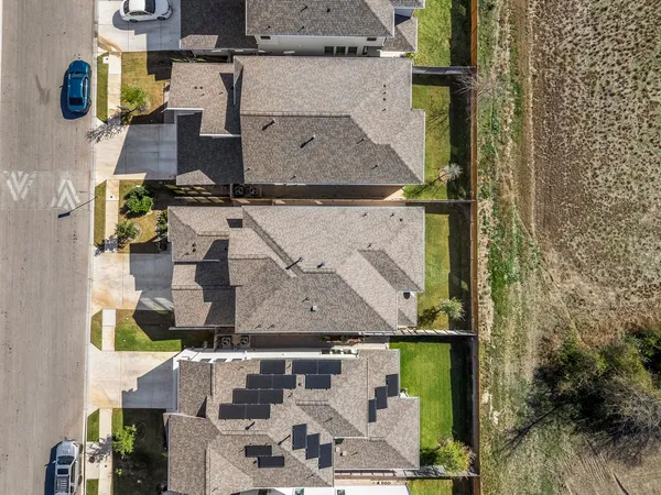 an aerial view of residential houses with outdoor space
