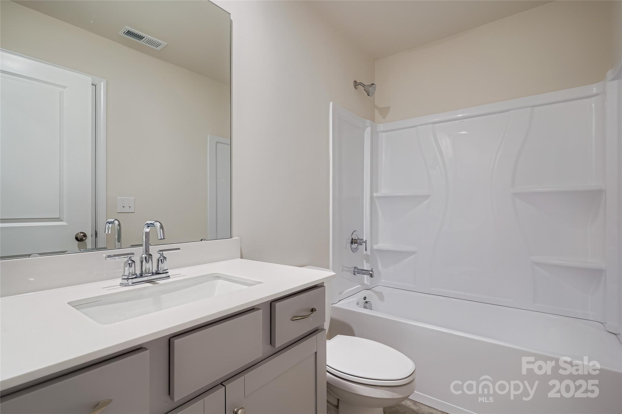 4344 Shimmering Stone Way Maiden, NC 28650 - Photo 11 of 13 a bathroom with a granite countertop sink a toilet and shower