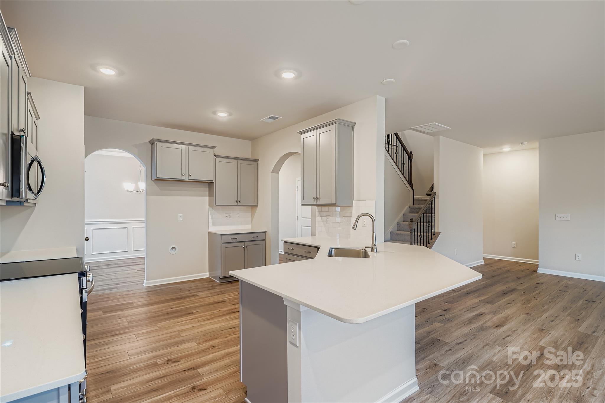 4344 Shimmering Stone Way Maiden, NC 28650 - Photo 4 of 13 a kitchen with a sink refrigerator and cabinets