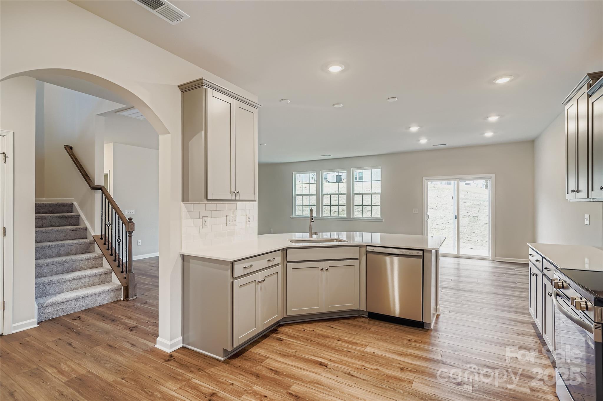 4344 Shimmering Stone Way Maiden, NC 28650 - Photo 5 of 13 a kitchen with a sink cabinets stainless steel appliances and windows