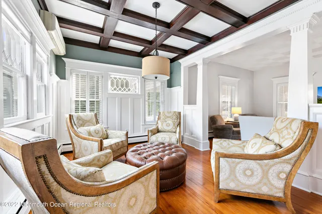 a living room with furniture and a chandelier