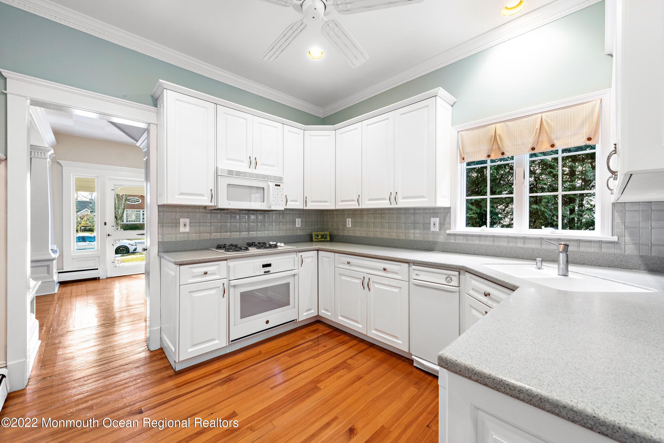 116 Tuttle Avenue Spring Lake, NJ 07762 - Photo 15 of 45 a kitchen with stainless steel appliances granite countertop a stove a sink and white cabinets