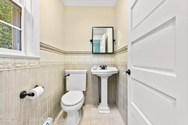 a bathroom with a sink toilet and mirror