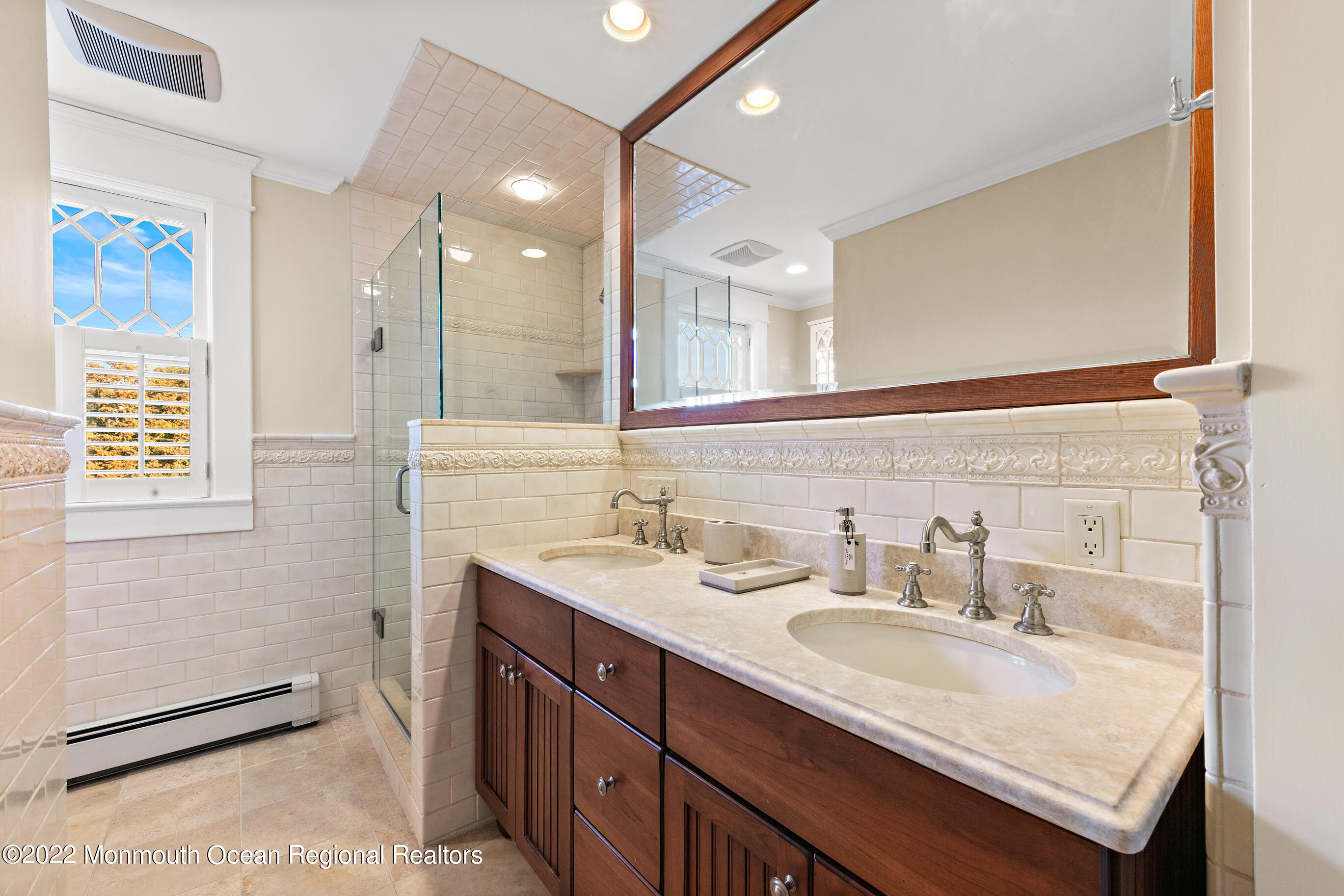 116 Tuttle Avenue Spring Lake, NJ 07762 - Photo 28 of 45 a bathroom with a granite countertop sink a mirror and a shower