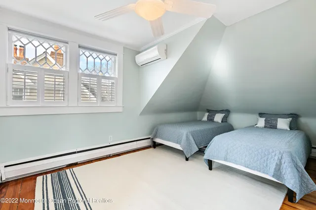 a bedroom with two beds and a window