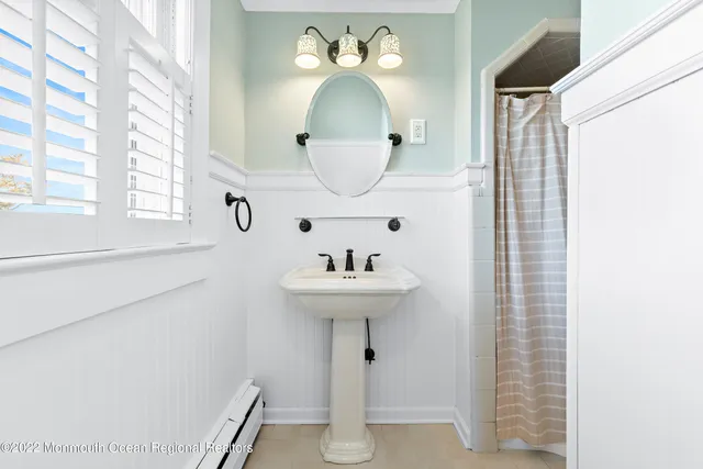 a bathroom with a sink a mirror and a window