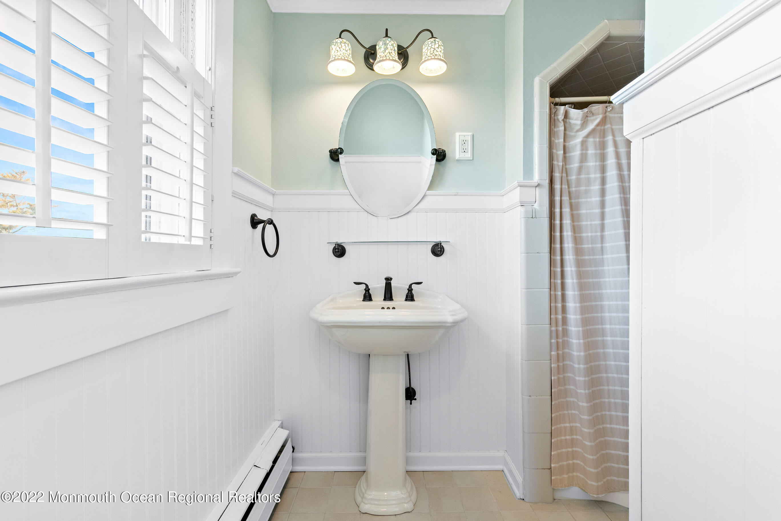 116 Tuttle Avenue Spring Lake, NJ 07762 - Photo 36 of 45 a bathroom with a sink a mirror and a window